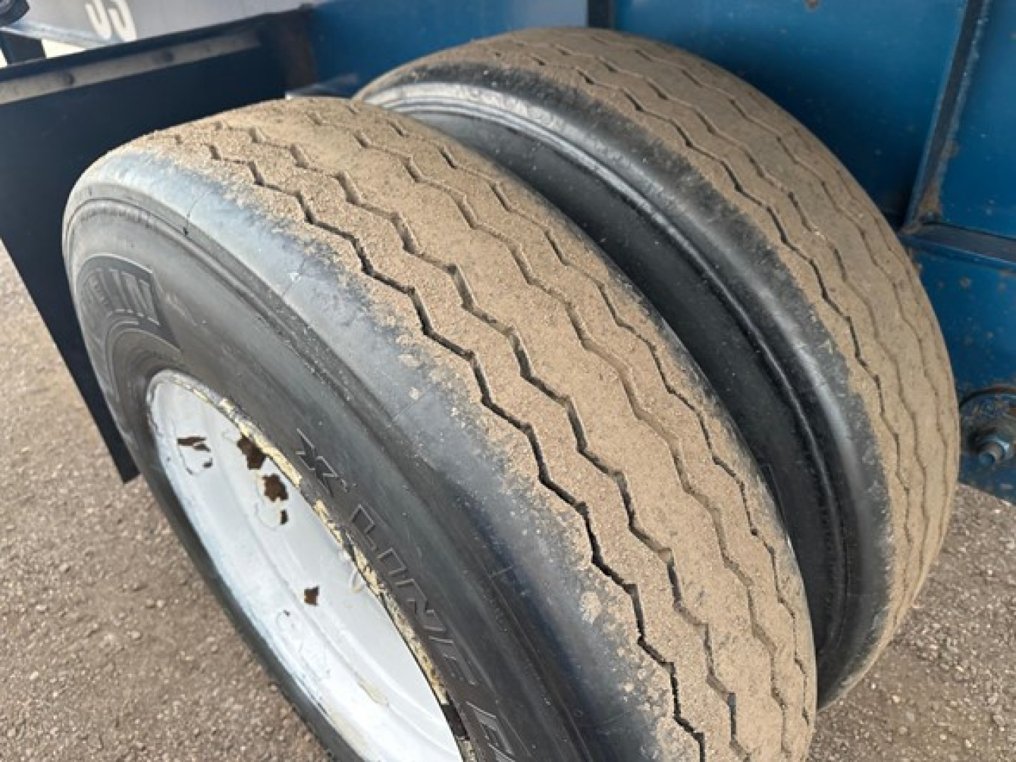Dual rear tires on a Great Dane flatbed trailer showing tread pattern and wheel rims.