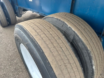Great Dane trailer dual wheels showing tread on tires and blue trailer body