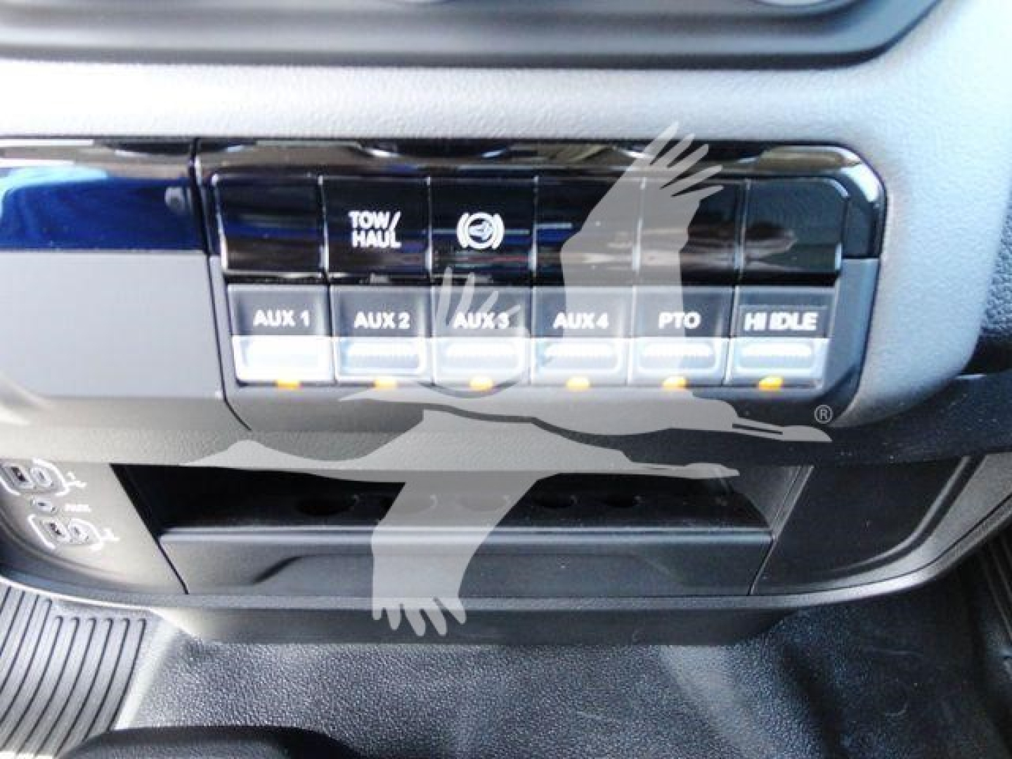 Ram 4500 dashboard panel with auxiliary switches labeled AUX 1 to AUX 6 and knobs for tow/haul, PTO, and H/L LED indicators.