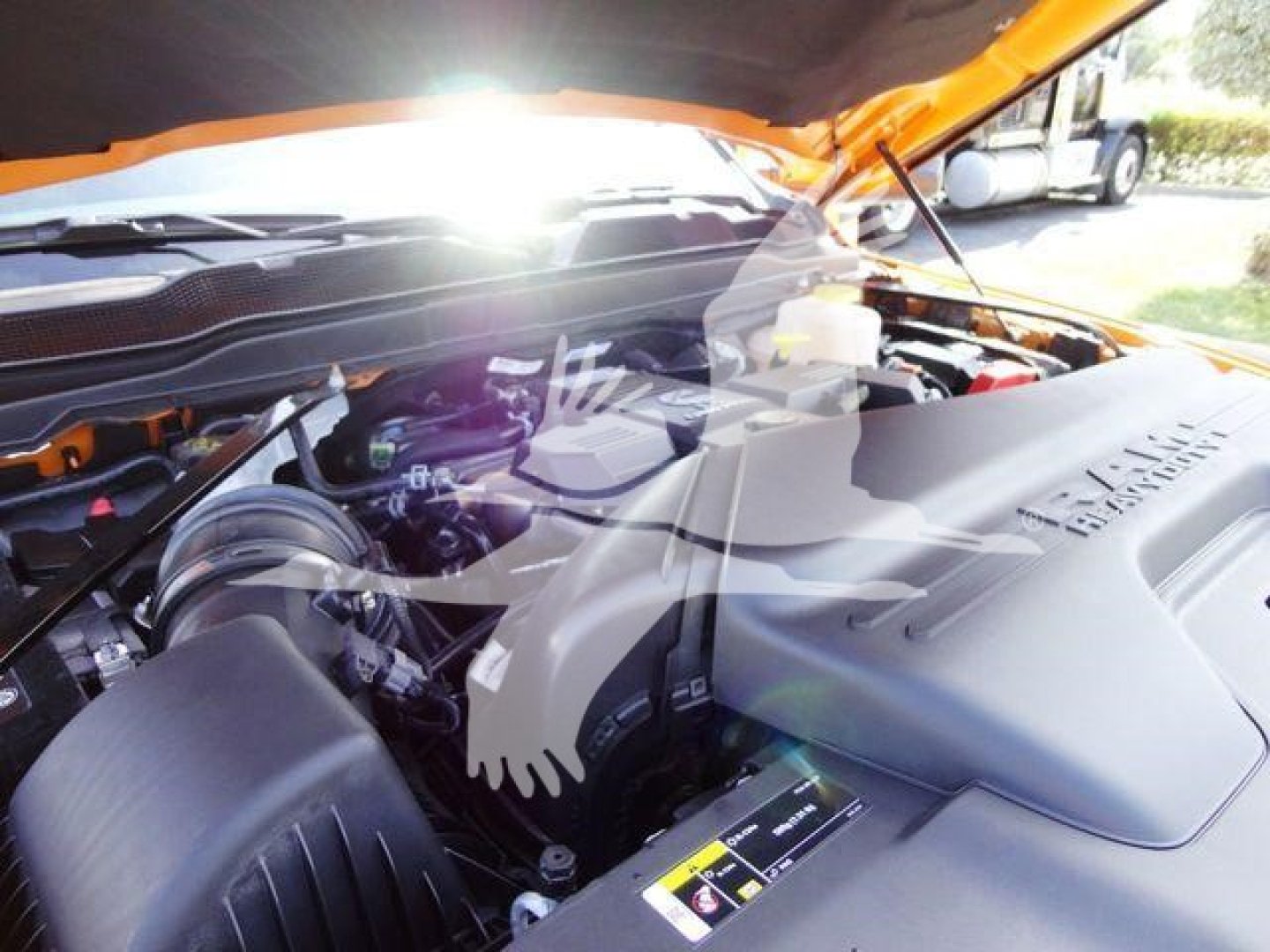 Ram 4500 engine bay showing intercooler piping and engine cover under orange hood.