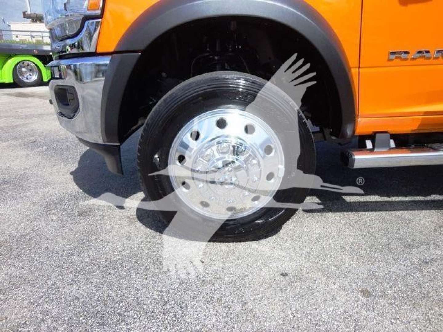 Ram 4500 front wheel view showing chrome hubcap and orange fender with 'RAM' badge.