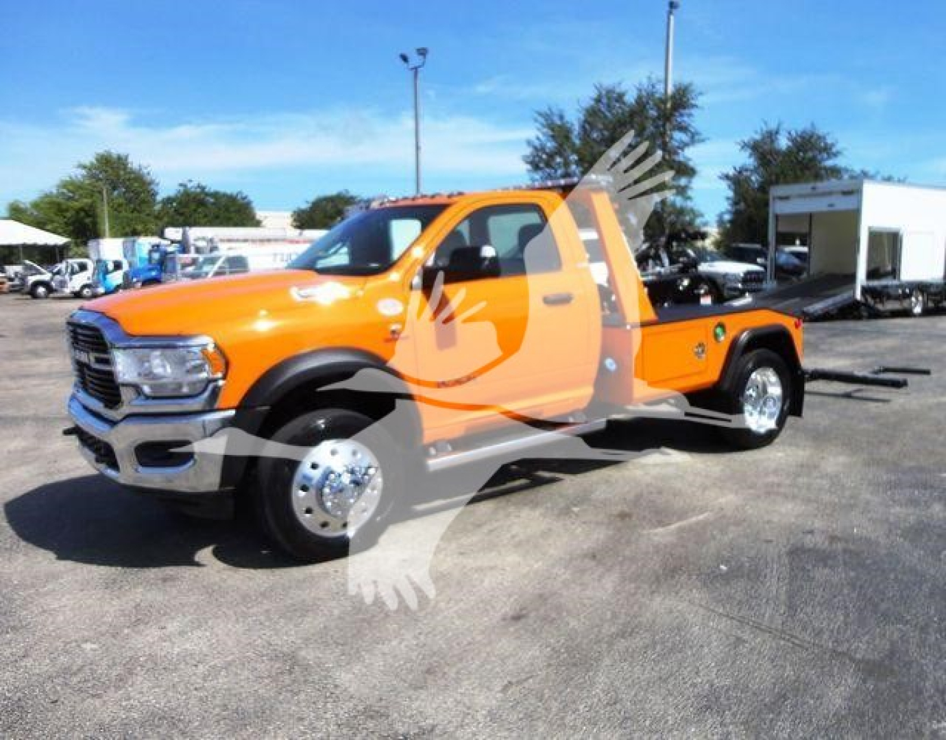 Orange Ram 4500 SLT pickup truck with tow winch, side view showing extended cab and dual rear wheels.