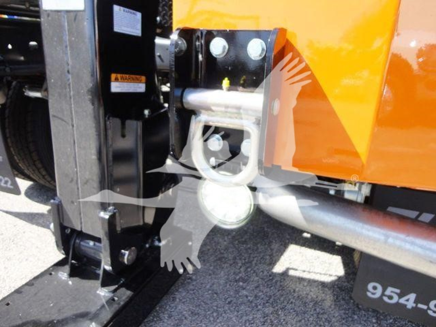 Ram 4500 diesel pickup winch setup showing front bumper, winch cradle, and heavy-duty towing hook assembly with hydraulic lines