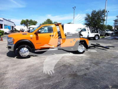 Ram 4500 SLT tow truck with utility bed and winch showing orange cab and black equipment.