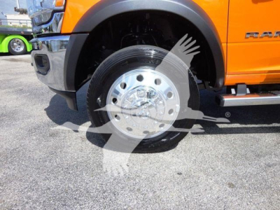 Ram 4500 front wheel view showing chrome hubcap and orange fender with 'RAM' badge.