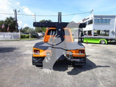 Truck bed with heavy-duty winch system in orange cab and black overhang, rear view