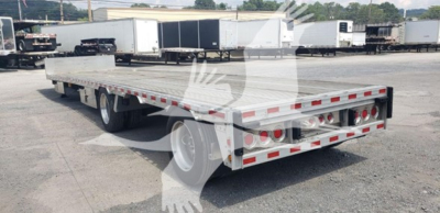 Trailer: 2018 Reitnouer Dropmiser lowbed flatbed with drop deck, rearview showing multiple taillights, reflective tape, and dual rear wheels.