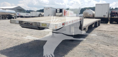 Flatbed trailer with drop deck showing aluminum deck and rear ramp sections.