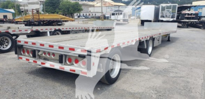 Flatbed trailer showing drop deck with reflective tape and rear lights, 2018 Reitnouer Dropmiser, steel frame, dual rear axles