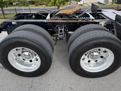 Kenworth T680 chassis showing dual rear axles with chrome wheels and tires, fuel tank area, and cab mount visible; VIN and stock number not visible in image.