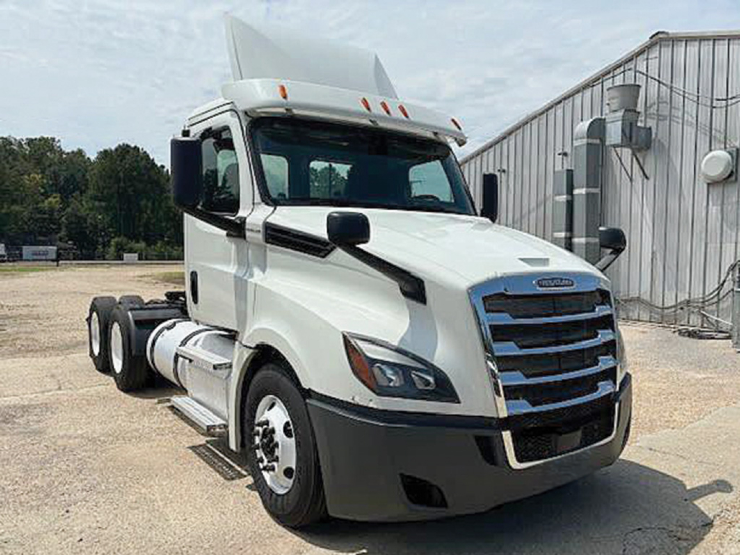 Freightliner Cascadia126 truck cab and front view showing white exterior, black grille, and side mirror details.