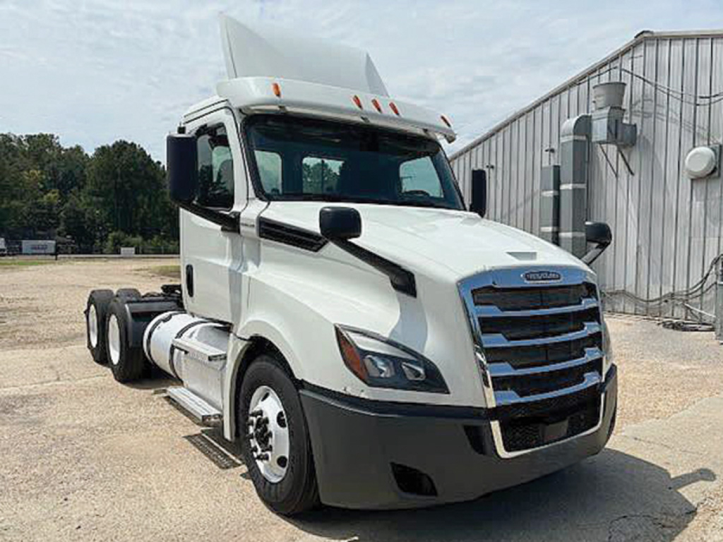 Freightliner Cascadia126 truck cab and front view showing white exterior, black grille, and side mirror details.