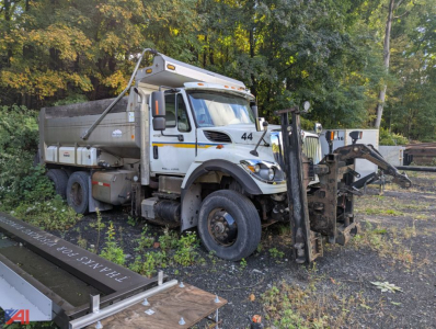 Dump truck 2012 International SF537 WorkStar 7500 with front-mounted plow and dump bed, side decals, in-service condition.