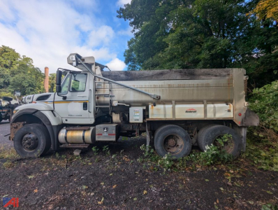 International SF537 WorkStar dump truck side view showing dump bed and front cab.