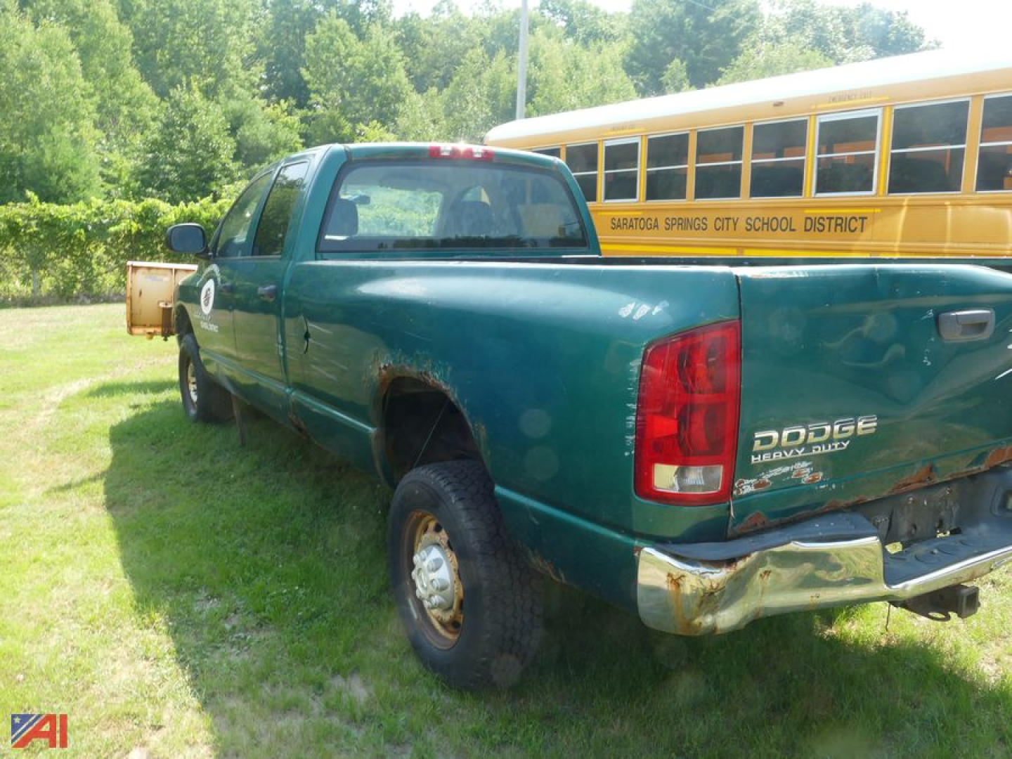 Dodge Ram 2500 pickup truck with quad cab and plow in rear view showing rear bumper and tailgate