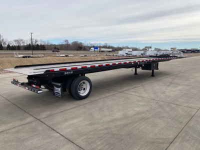 Long black Landoll trailer with red/white reflective tape, flatbed container trailer, serial text '3439' on side, single rear axle, two ramps at back.