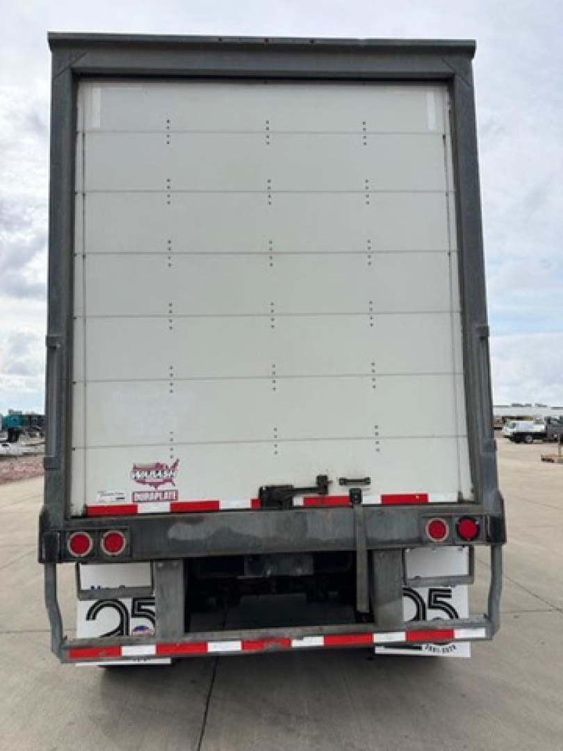 Rear view of a 2017 Wabash trailer with closed vertical liftgate, showing taillights, bumper, and reflective stripes. VIN tag and stock number not visible clearly.