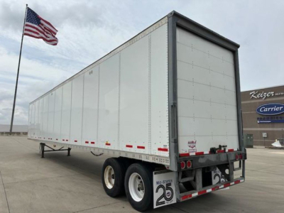 Trailer side and rear of a 2017 Wabash van trailer showing dual rear axles, white aluminum walls, and rear doors.