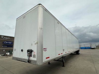 Trailer shows an empty white 2017 Wabash van trailer with swing-out nose and landing gear, side view with registration stickers and wheel area visible.