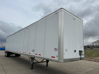 Trailer side view showing a white Wabash van trailer with side panels, 53' length marking, landing gear, and rear doors.