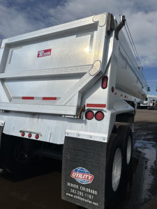 Travis frameless aluminum end dump trailer rear view showing tail lights and mudflap with Utility logo and Denver, Colorado contact info.