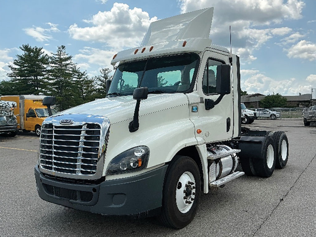 Truck cab showing Freightliner Cascadia125 with raised hood in a parking lot, front grille, headlights, side mirrors, and dual rear axles.
