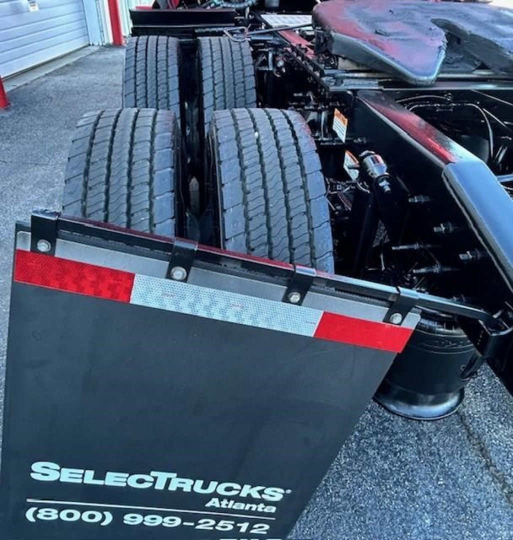 Freightliner Cascadia 126 chassis view showing dual rear axles and Select Trucks Atlanta logo on mudguard.