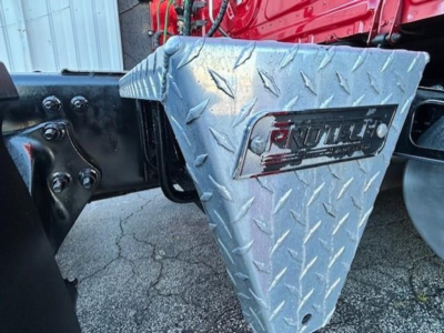 Truck step/storage box with diamond plate pattern and 'RATTLEBOX' logo on surface, mounted near cab of Freightliner Cascadia 126.