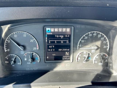 Dashboard of a Freightliner Cascadia showing instrument cluster and center digital display with trip mpg: 10.3, outside temp 62°F, fuel 14.2V 481,508 mi, N gear, 07:40 time.