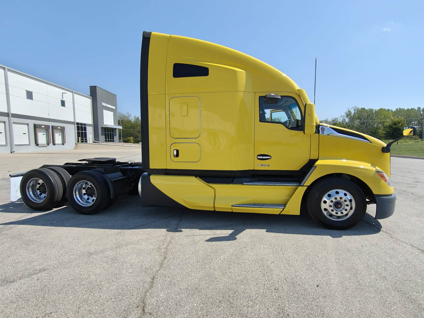 Kenworth T680 cab and tractor in yellow, side view with sleeper, engine hood open, no identifying logos visible on cab