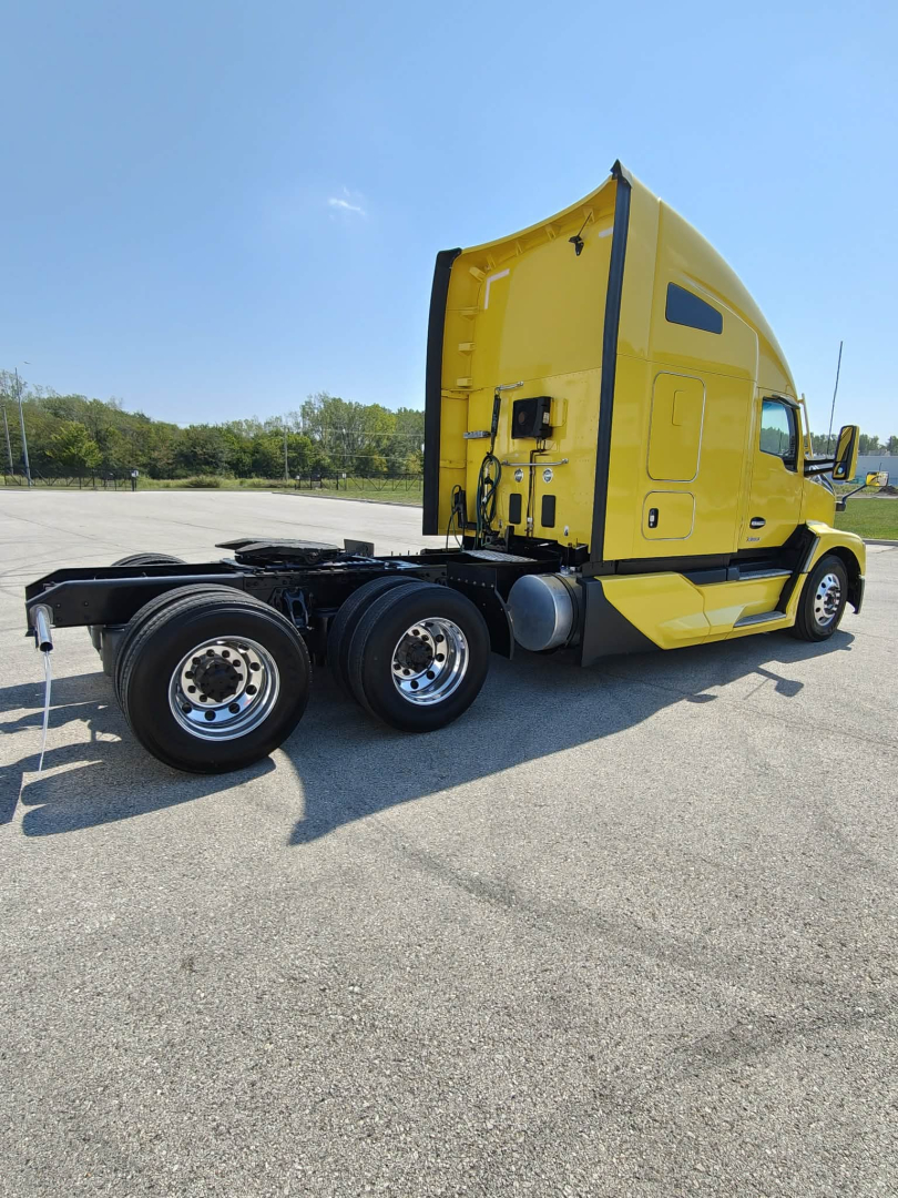Kenworth T680 tractor truck in yellow, side view, with sleeper cab and three rear wheels visible; chassis and fuel tanks visible under cab; no readable serials or stickers.
