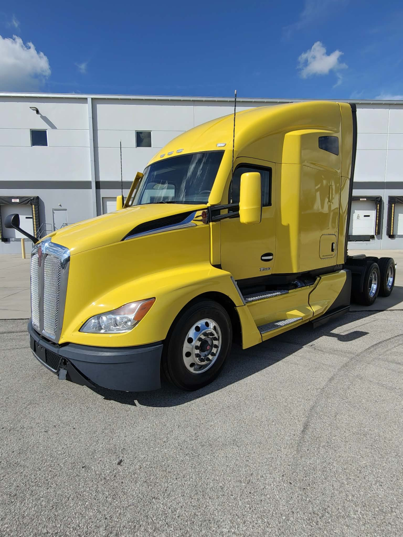 Yellow 2023 Kenworth T680 tractor in sleeper configuration, front-left view, VIN 1XKYDP9X9PJ243749, stock 0630364, conventional truck image.