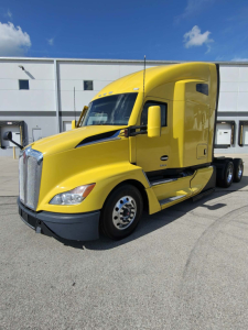 Yellow 2023 Kenworth T680 tractor in sleeper configuration, front-left view, VIN 1XKYDP9X9PJ243749, stock 0630364, conventional truck image.