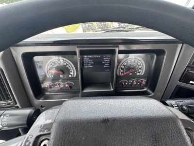 Dashboard view inside a 2020 Mack PI64T showing instrument clusters, center display, steering wheel, and indicators.