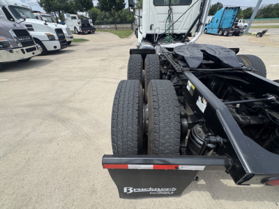 Rear view of a 2020 Mack PI64T tractor chassis showing dual rear axles and trailer hitch area with Brackett-braker? brand plate on mudguard.