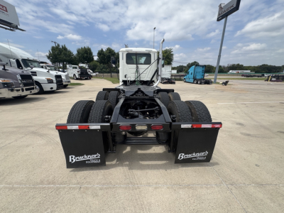 Mack PI64T tractor chassis rear view showing dual rear axles and mud flaps with Bruchner's logo