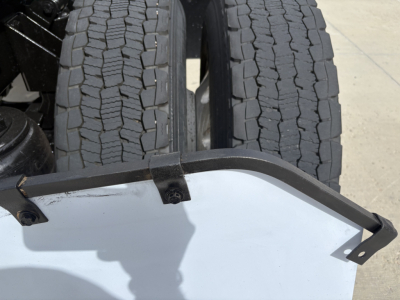 Kenworth T880 truck image showing dual rear tires and a partial bumper guard with light residue.