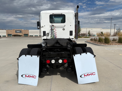 AWD Kenworth T880 tractor rear view showing mud flaps with MHC logos and fifth-wheel area.