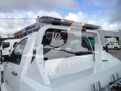 Truck bed showing rollover protection and rear view with winch-equipped Silverado 6500HD stance, cab, and rack.