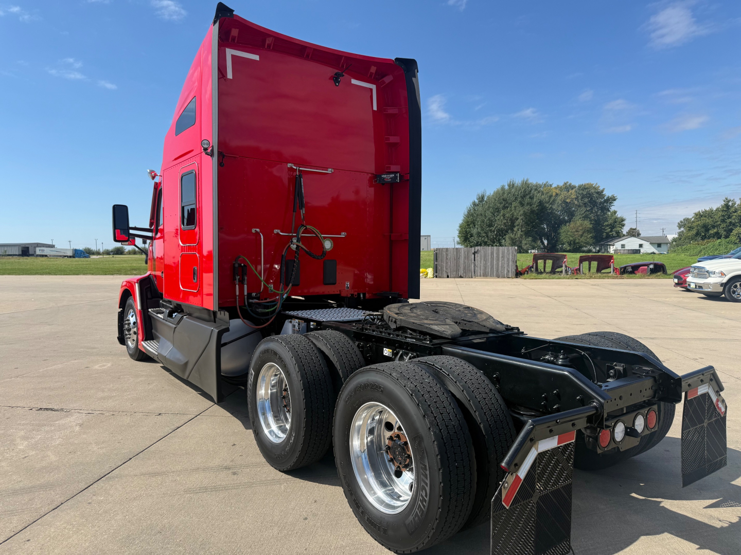 Kenworth T680 conventional sleeper truck rear view showing dual rear axles and fifth wheel.