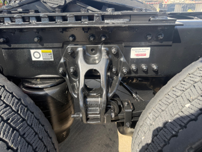 Kenworth T680 chassis showing rear hitch assembly and suspension components with dual tires and mounting hardware