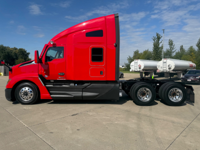 Kenworth T680 truck side profile showing red sleeper cab and dual rear axles with fuel tanks.