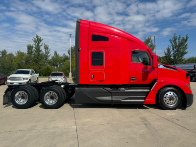 Kenworth T680 tractor in red side view showing sleeper cab, chassis, and wheels with triple rear axles.
