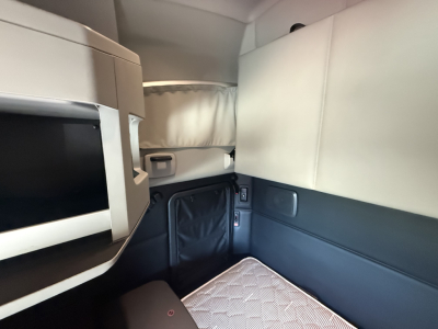 Kenworth T680 sleeper cab interior showing bunk area and storage compartments.