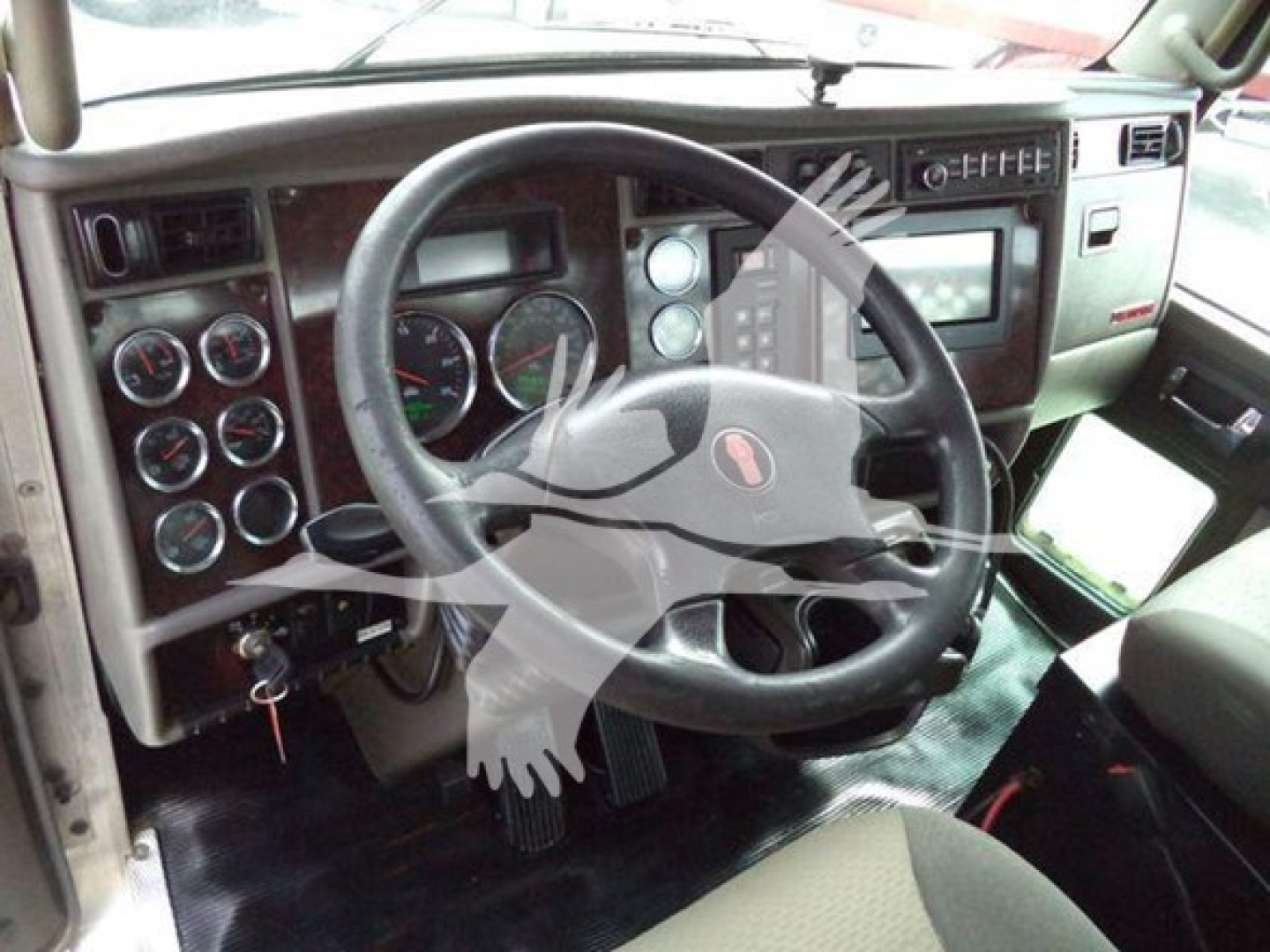 Kenworth T270 dash and steering wheel with multiple gauges and control panels visible in the cab interior.