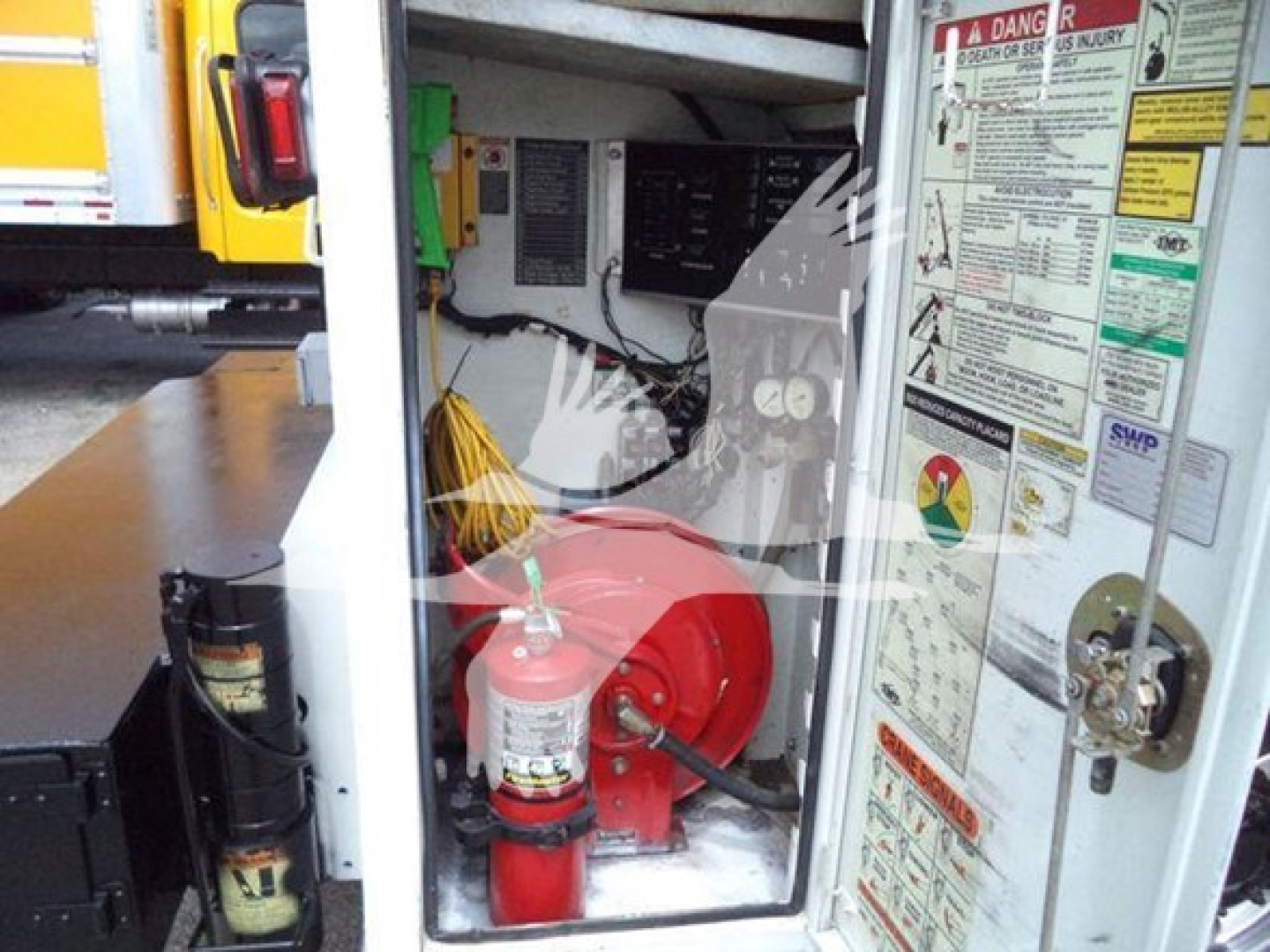 Kenworth T270 engine bay area with red fire extinguisher and warning label panels visible
