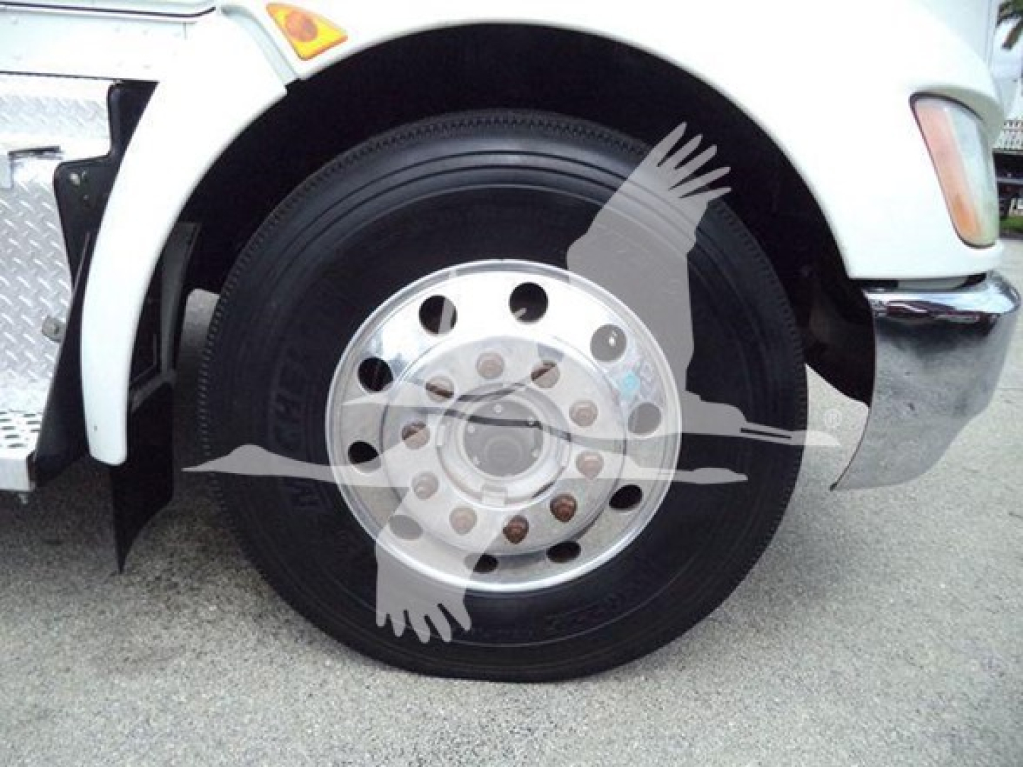 Kenworth T270 front wheel showing steel rim and tire, partial fender and bumper.