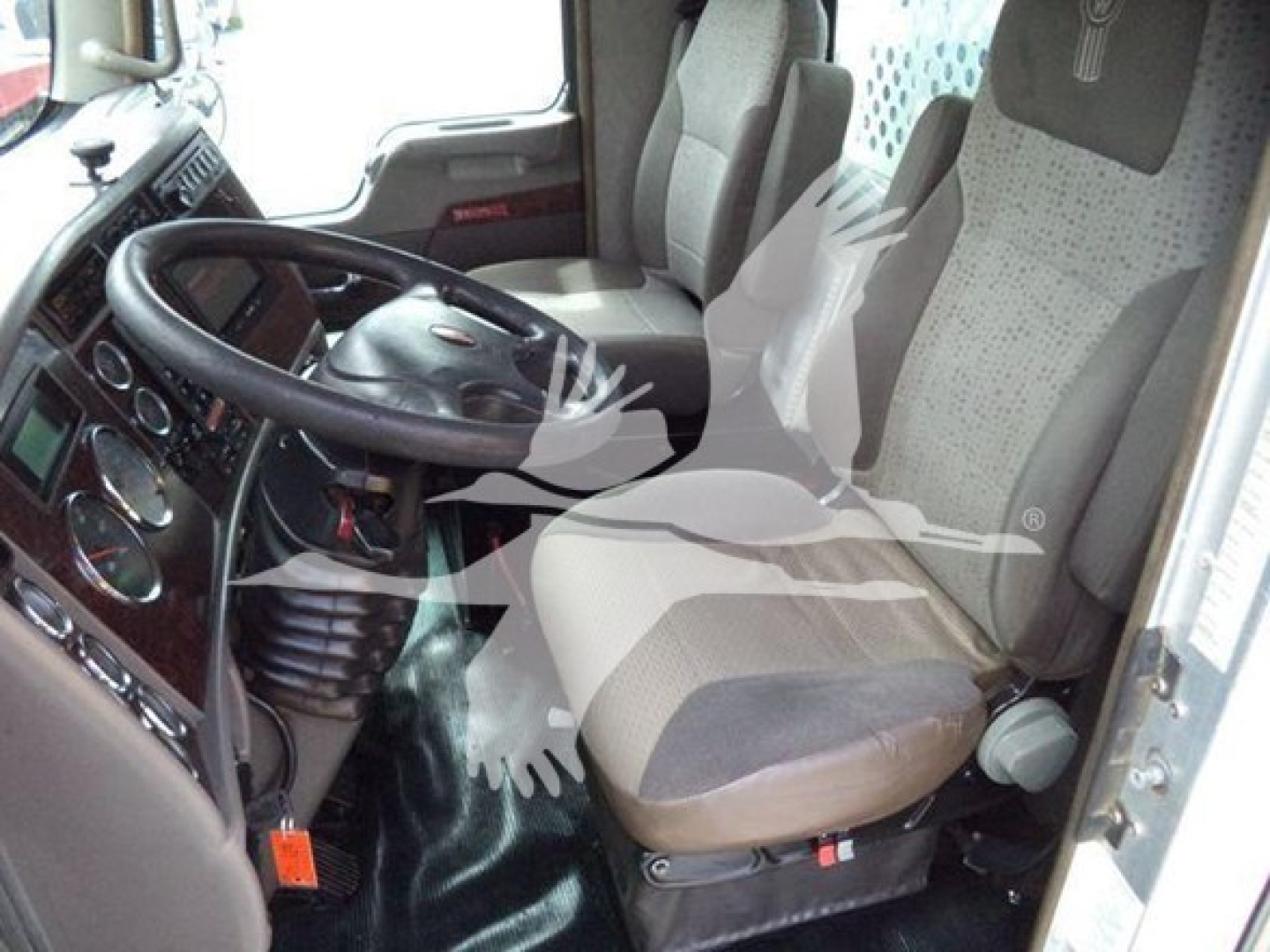 Kenworth T270 cab interior showing steering wheel, dashboard, and two-tone driver seat