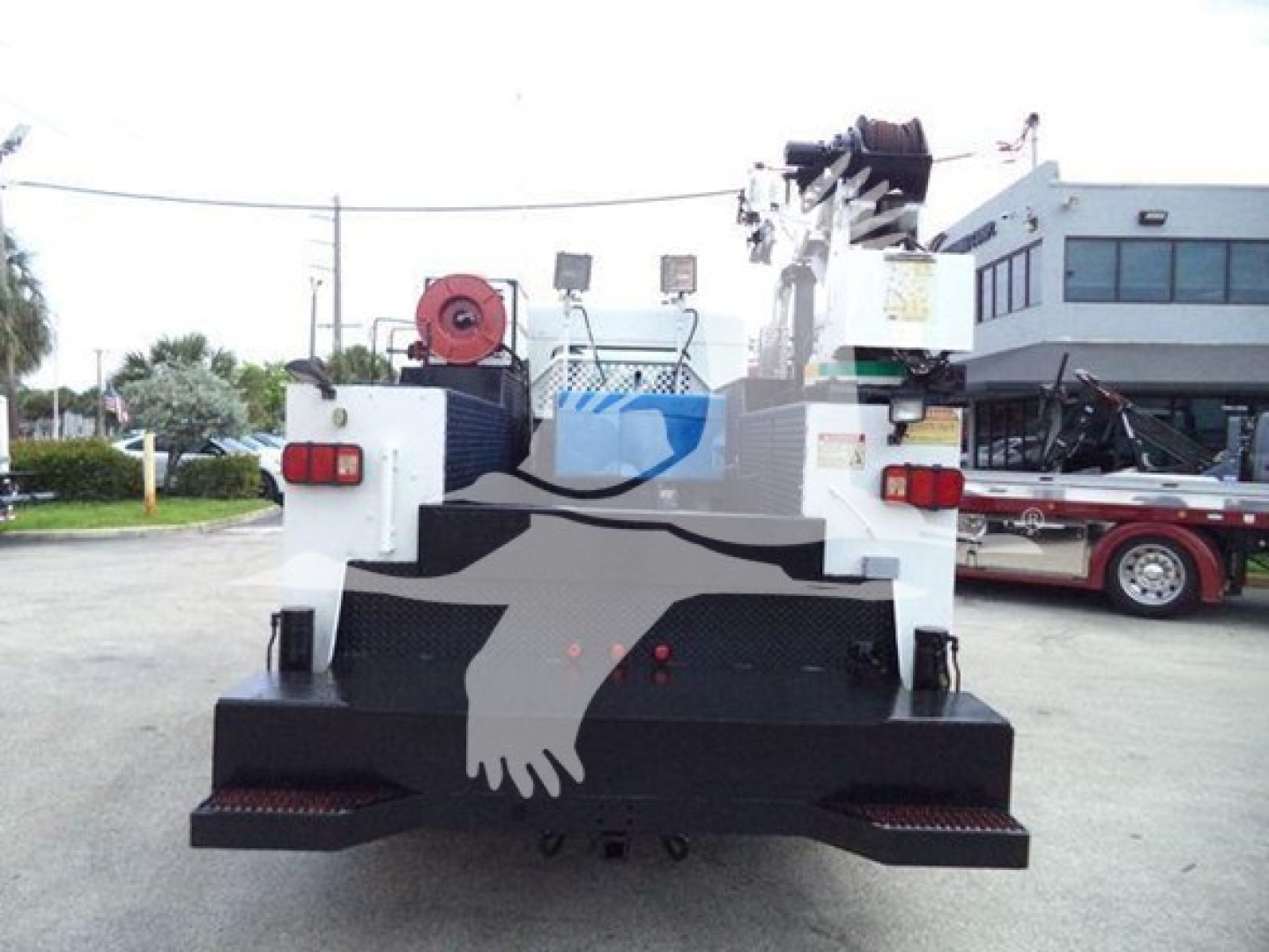 Kenworth T270 rear view showing heavy-duty tow hoist and hydraulic components, and rear bumper with mirror silhouette graphic.