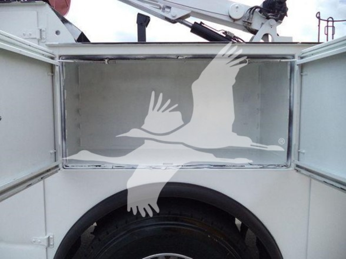 Kenworth T270 service truck cargo area with open compartments and crane arm visible, reflective interior surface.